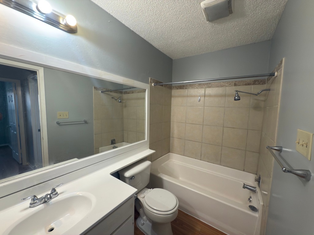 1312 Southport Drive, Unit B Austin, TX 78704 - Photo 14 of 15 a bathroom with a sink a toilet and shower