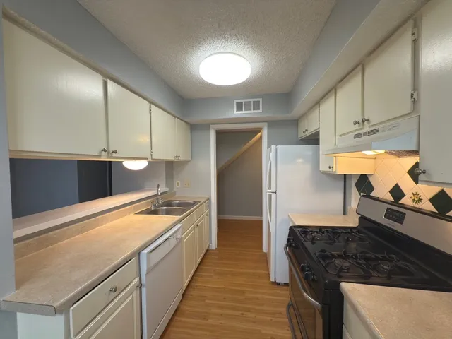 a kitchen with a stove and a refrigerator