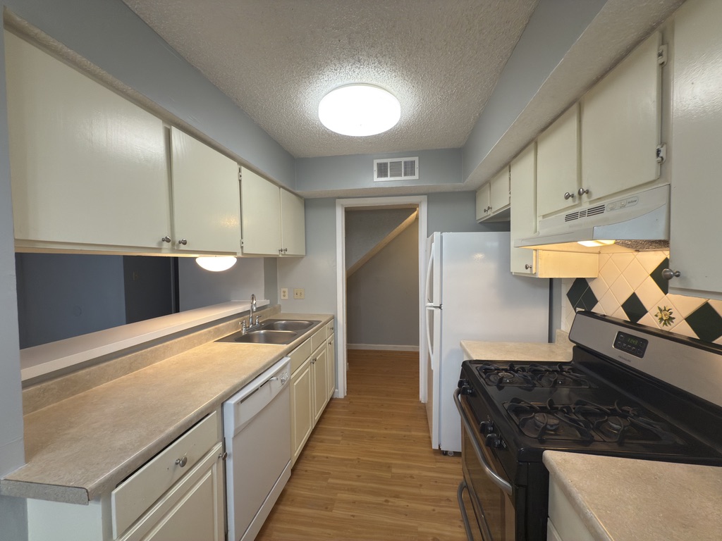 1312 Southport Drive, Unit B Austin, TX 78704 - Photo 4 of 15 a kitchen with stainless steel appliances granite countertop a sink and a stove