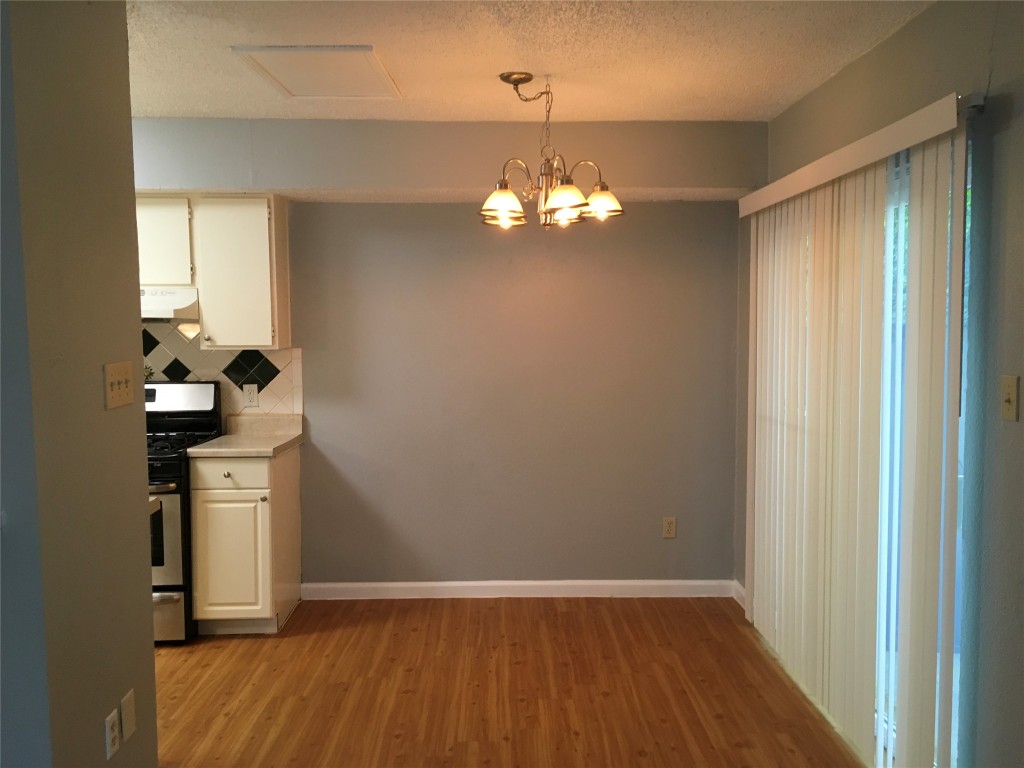 1312 Southport Drive, Unit B Austin, TX 78704 - Photo 5 of 15 a view of a room with wooden floor chandelier and closet
