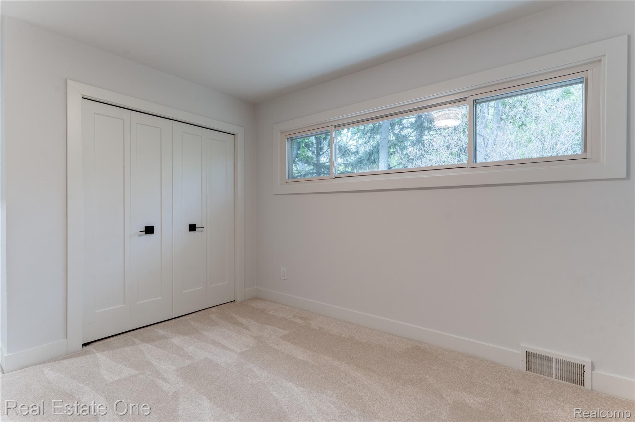 786 South Cranbrook Road Bloomfield Hills, MI 48301 - Photo 18 of 38 Unfurnished bedroom with light colored carpet and a closet
