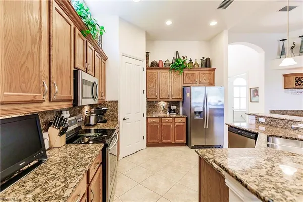 a kitchen with refrigerator and window
