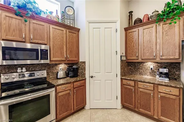 a kitchen with stainless steel appliances granite countertop a stove microwave and cabinets