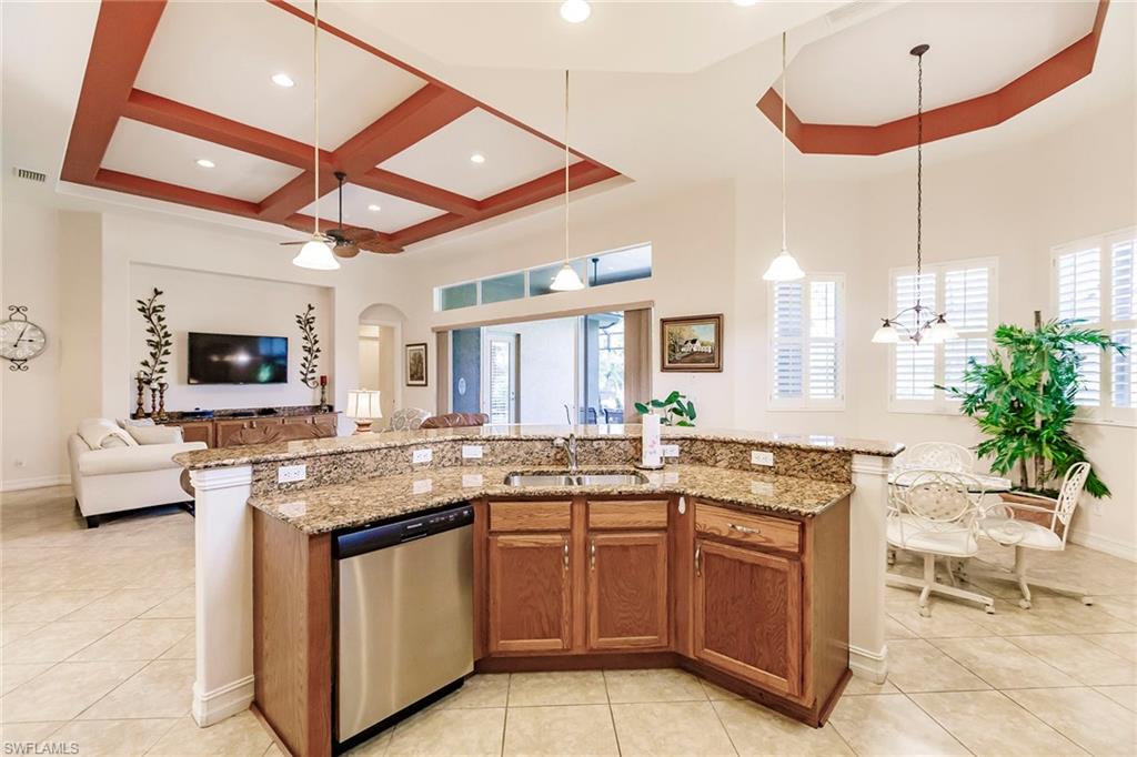 7684 Cottesmore Drive Naples, FL 34113 - Photo 18 of 46 a kitchen with a sink and a stove