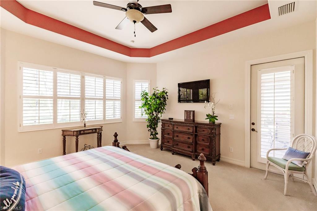 7684 Cottesmore Drive Naples, FL 34113 - Photo 29 of 46 a bedroom with a bed and furniture with window