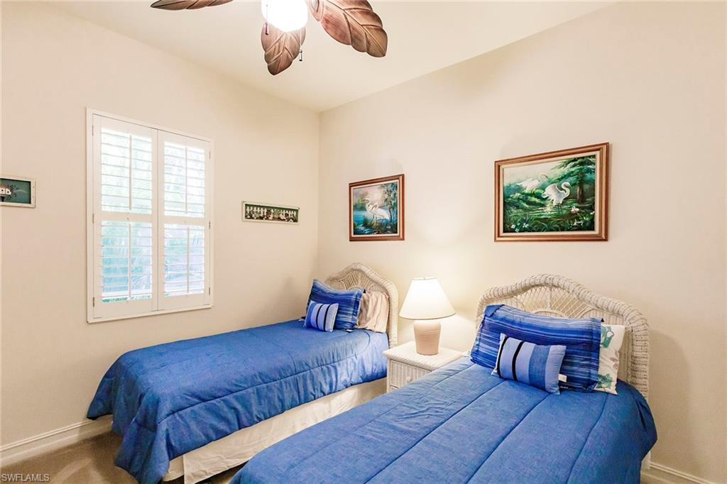7684 Cottesmore Drive Naples, FL 34113 - Photo 40 of 46 a bedroom with furniture and a window