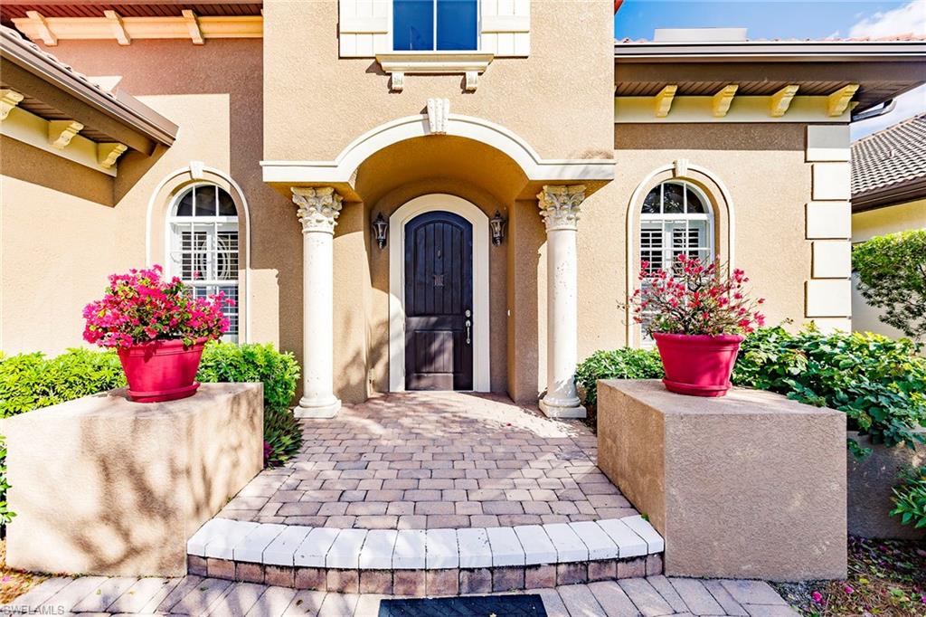 7684 Cottesmore Drive Naples, FL 34113 - Photo 4 of 46 a front view of a house with a porch