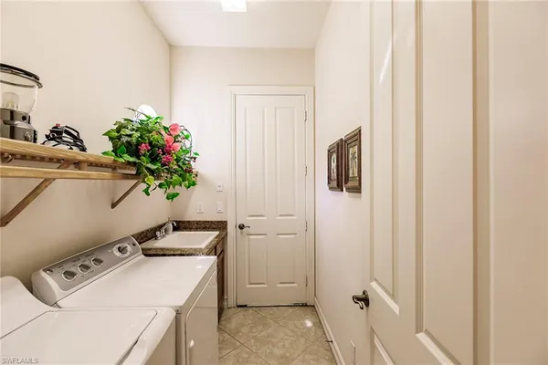 a utility room with closet dryer and washer