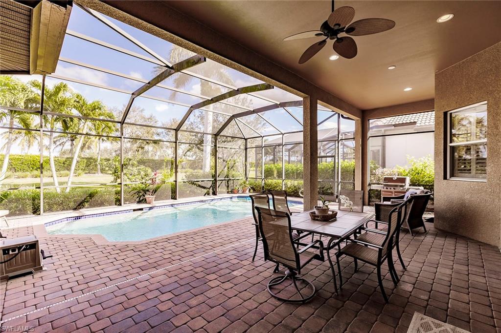 7684 Cottesmore Drive Naples, FL 34113 - Photo 45 of 46 a dining room with furniture and a floor to ceiling window