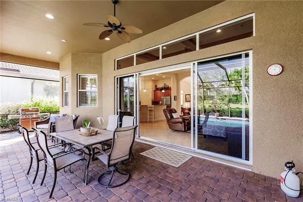 a dining room with furniture and a floor to ceiling window