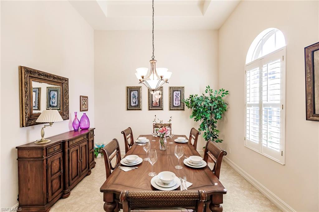 7684 Cottesmore Drive Naples, FL 34113 - Photo 7 of 46 a view of a dining room with furniture window and wooden floor