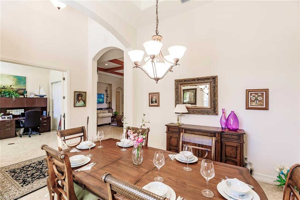 7684 Cottesmore Drive Naples, FL 34113 - Photo 9 of 46 a living room with fireplace furniture and wooden floor