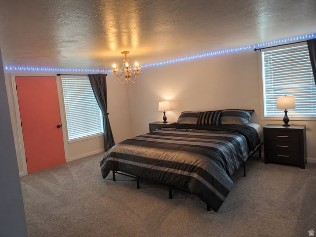 287 100 North Orem, UT 84057 - Photo 10 of 18 Bedroom with carpet, hanging lights, and a textured ceiling