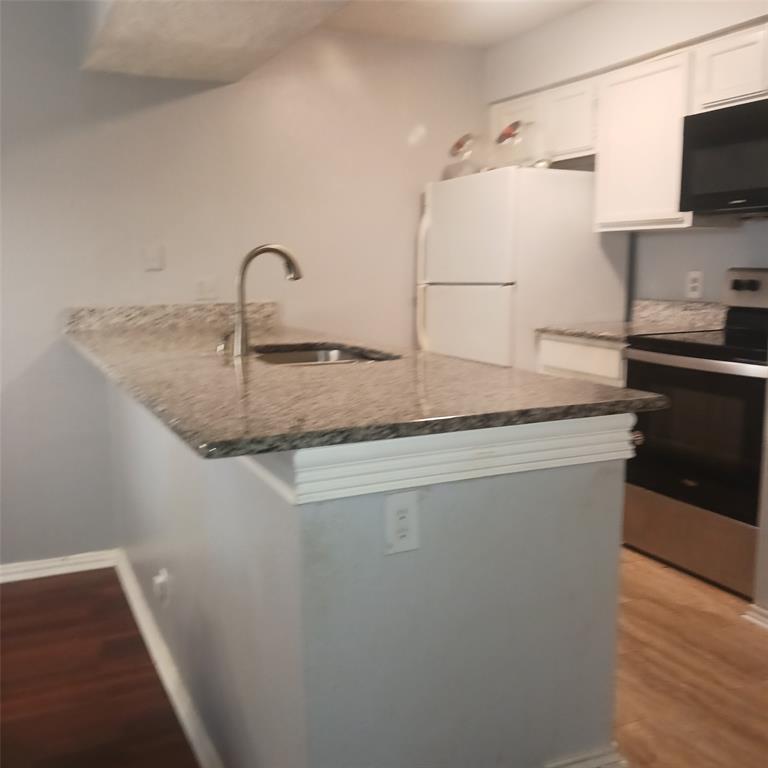 5750 Phoenix Drive, Unit 33 Dallas, TX 75231 - Photo 1 of 14 a kitchen with a sink a stove and refrigerator