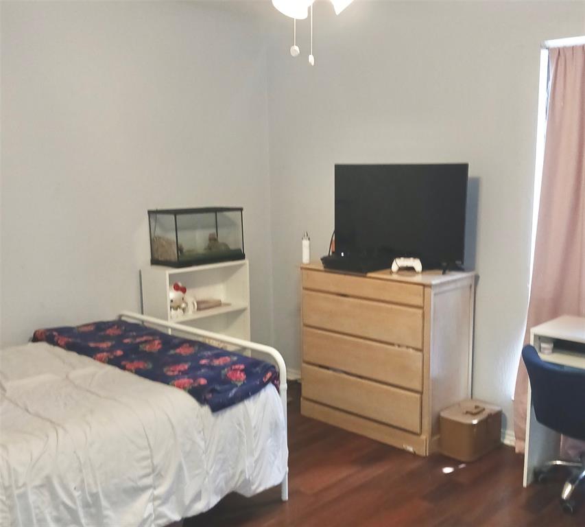 5750 Phoenix Drive, Unit 33 Dallas, TX 75231 - Photo 12 of 14 a bedroom with a bed and a flat screen tv
