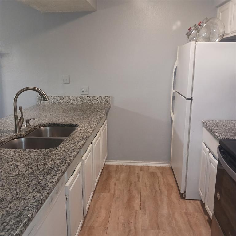5750 Phoenix Drive, Unit 33 Dallas, TX 75231 - Photo 13 of 14 a kitchen with stainless steel appliances granite countertop a sink stove and refrigerator