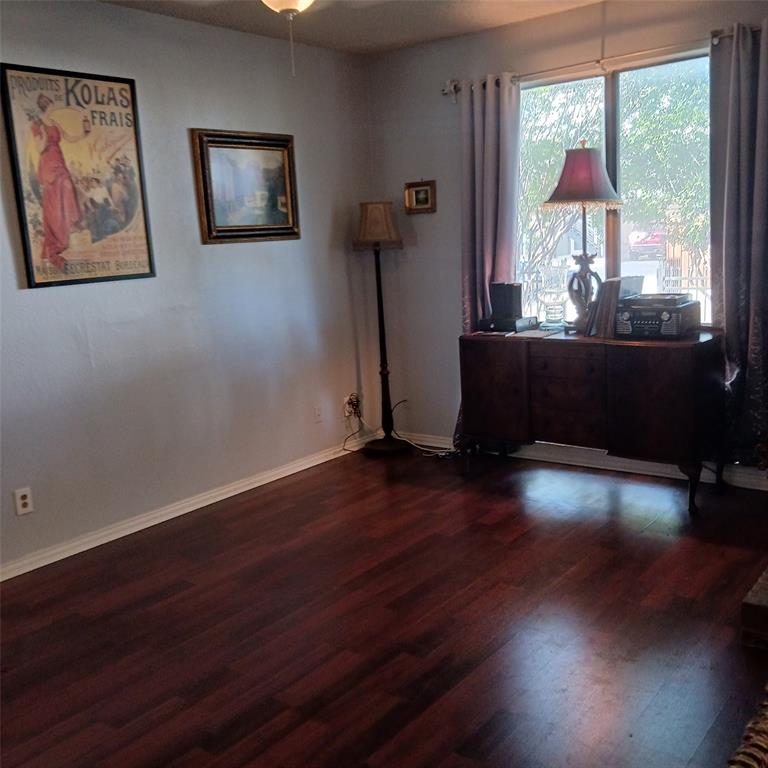 5750 Phoenix Drive, Unit 33 Dallas, TX 75231 - Photo 8 of 14 a view of a livingroom with wooden floor and a floor to ceiling window