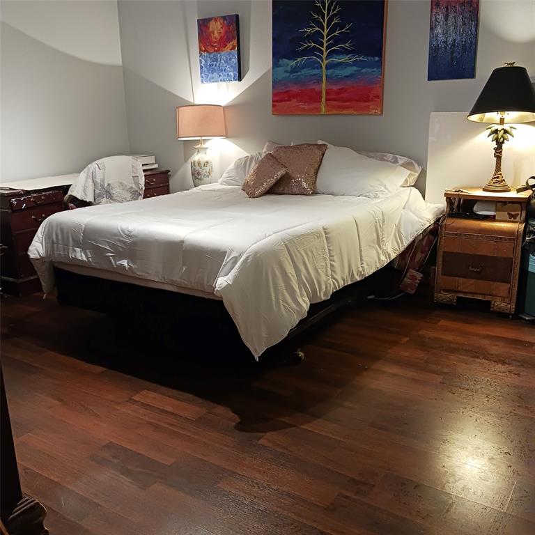 5750 Phoenix Drive, Unit 33 Dallas, TX 75231 - Photo 9 of 14 a bedroom with a bed and a lamp