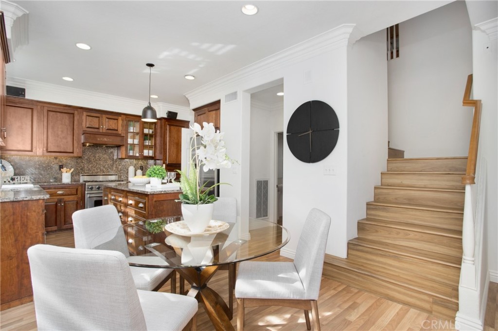 10 Bel Spring Irvine, CA 92602 - Photo 13 of 35 a dining room with furniture and wooden floor