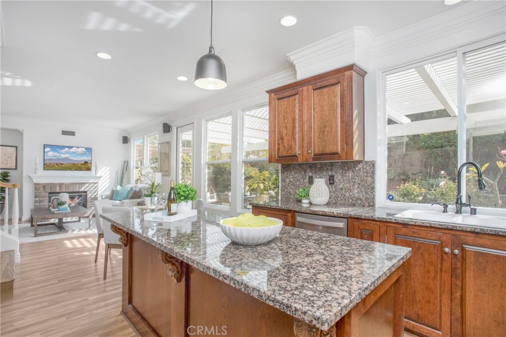 10 Bel Spring Irvine, CA 92602 - Photo 14 of 35 a kitchen with granite countertop a sink a counter top space and living room view