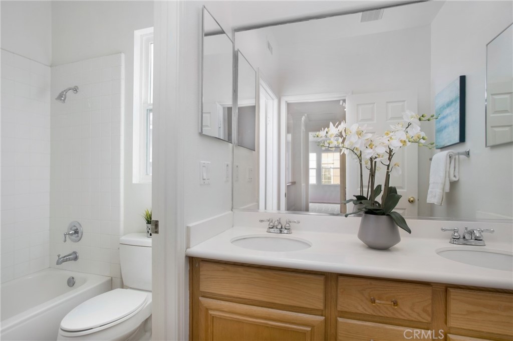 10 Bel Spring Irvine, CA 92602 - Photo 20 of 35 a bathroom with a double vanity sink toilet and shower