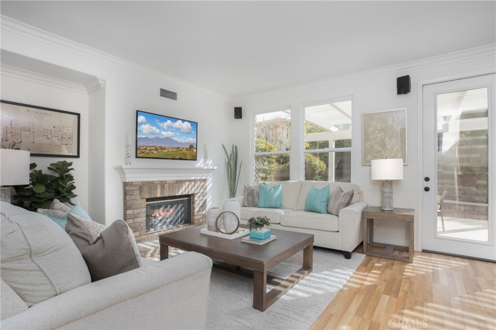 10 Bel Spring Irvine, CA 92602 - Photo 4 of 35 a living room with furniture large window and a fireplace