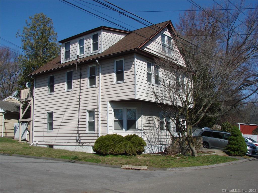 a front view of a house with a garden and plants