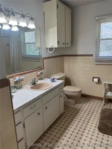 a bathroom with a sink toilet and mirror