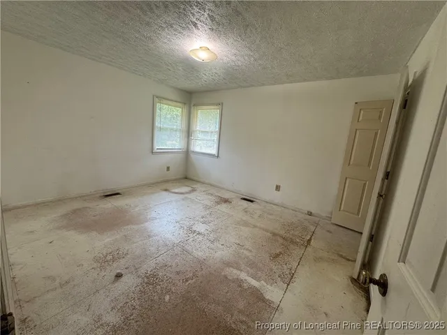 a view of an empty room and closet