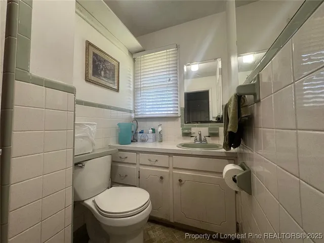 a bathroom with a glass door shower a toilet and a sink