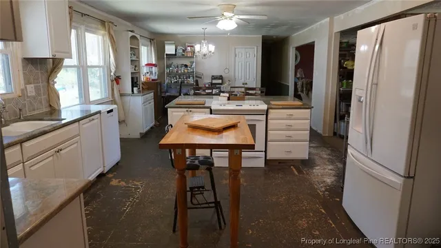 a kitchen with stainless steel appliances a sink stove and refrigerator