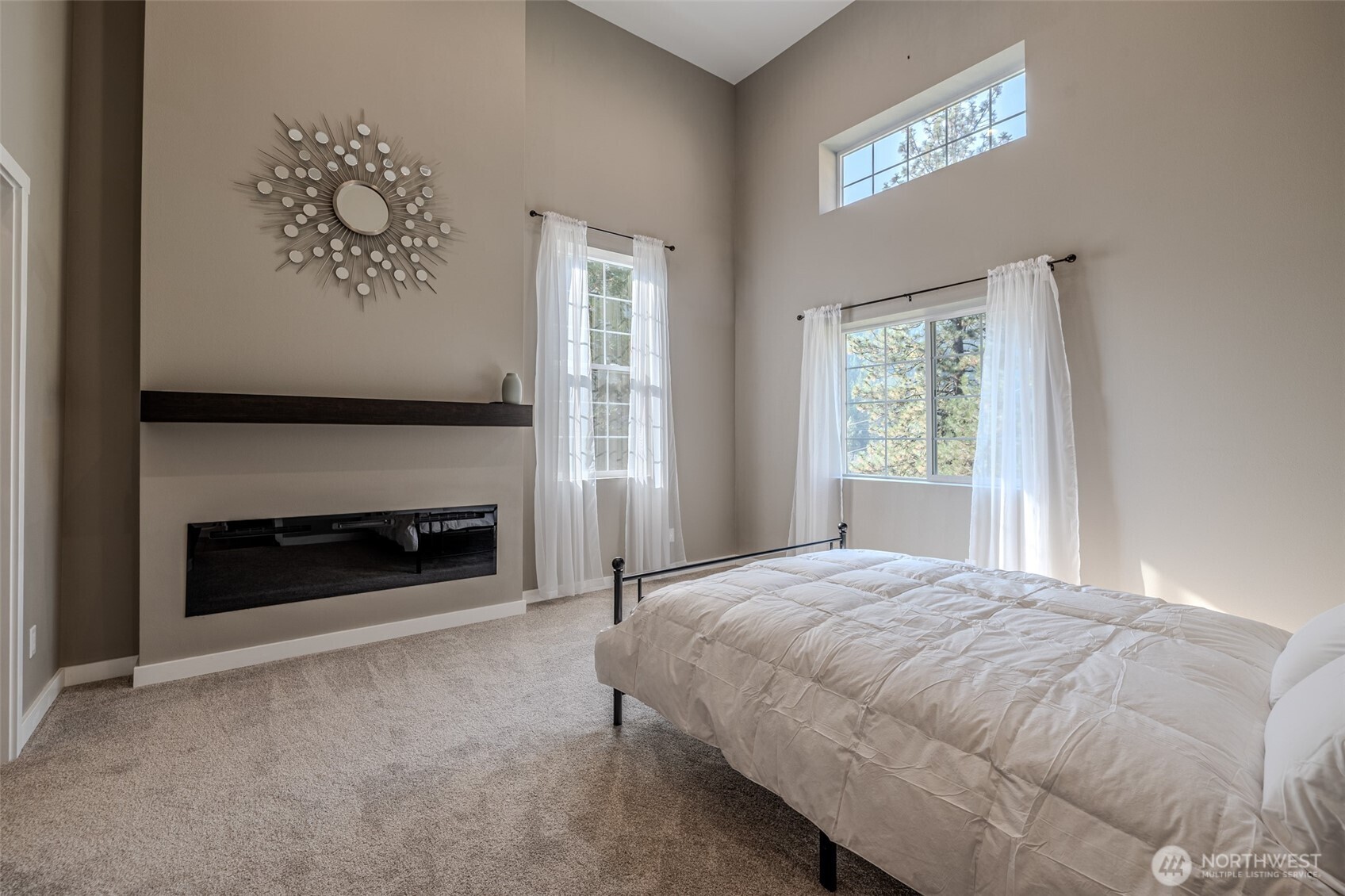 10642 Merry Canyon Road Leavenworth, WA 98826 - Photo 16 of 36 a bedroom with a bed and a fireplace