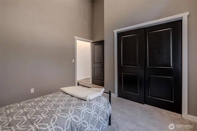 a bathroom with a sink a toilet a mirror and shower