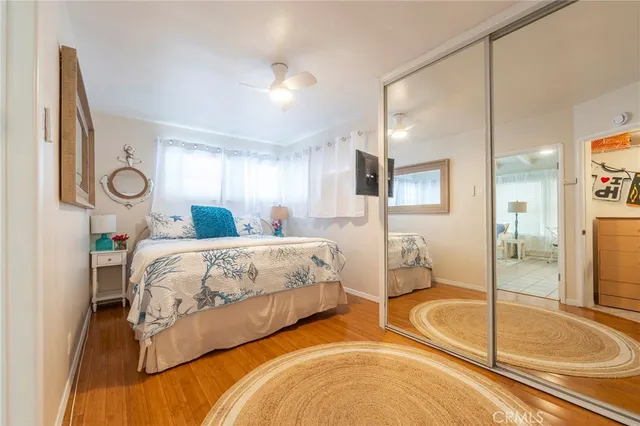 a spacious bedroom with a bed and glass door