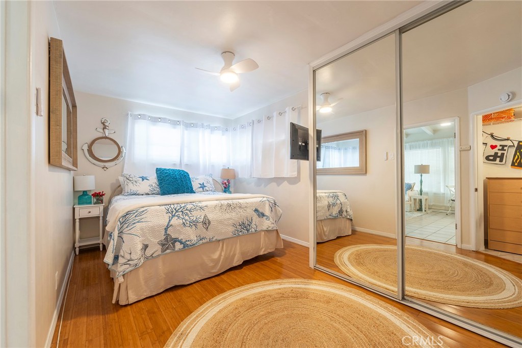 1728 The Strand, Unit 4 Hermosa Beach, CA 90254 - Photo 13 of 23 a spacious bedroom with a bed and glass door