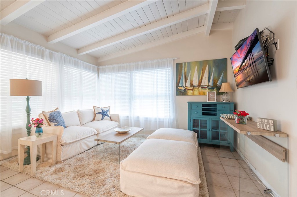 1728 The Strand, Unit 4 Hermosa Beach, CA 90254 - Photo 14 of 23 a living room with furniture and a flat screen tv