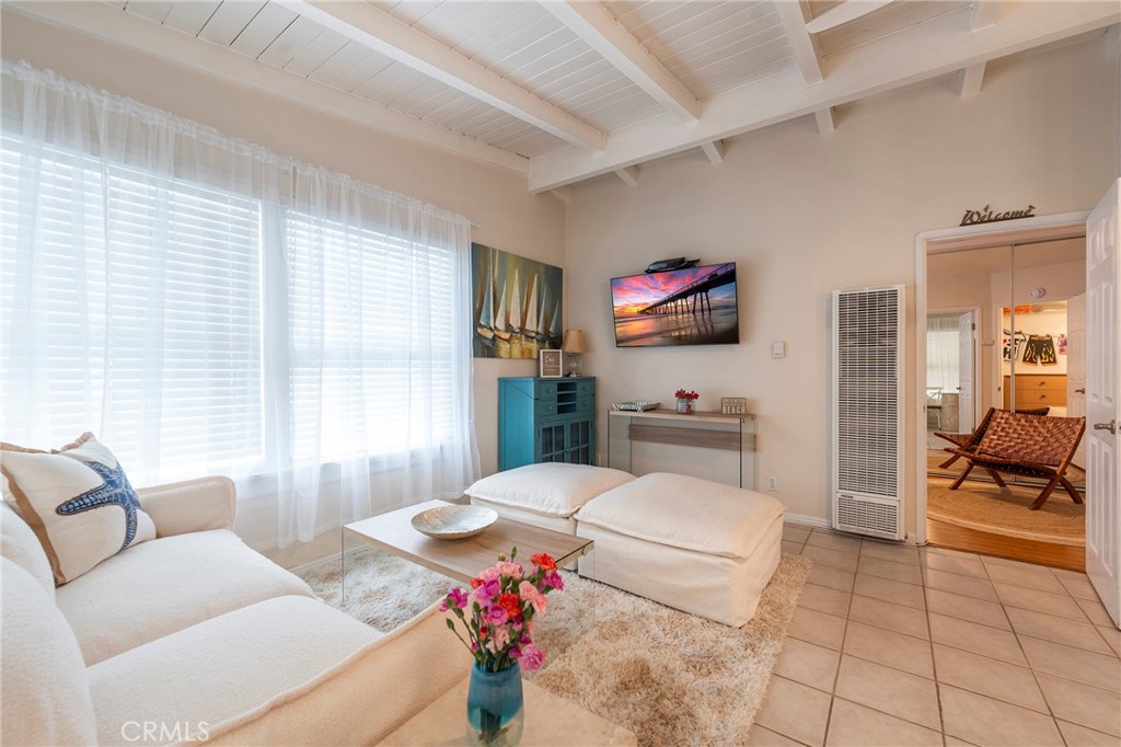 1728 The Strand, Unit 4 Hermosa Beach, CA 90254 - Photo 15 of 23 a living room with furniture and a flat screen tv