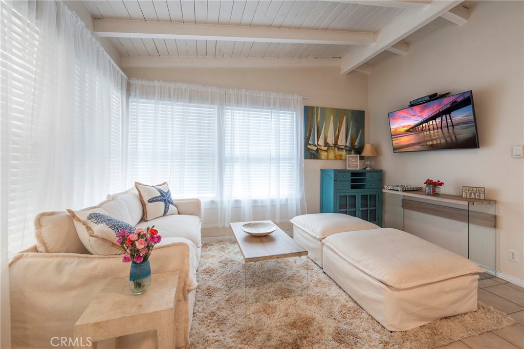 1728 The Strand, Unit 4 Hermosa Beach, CA 90254 - Photo 18 of 23 a living room with furniture and a flat screen tv