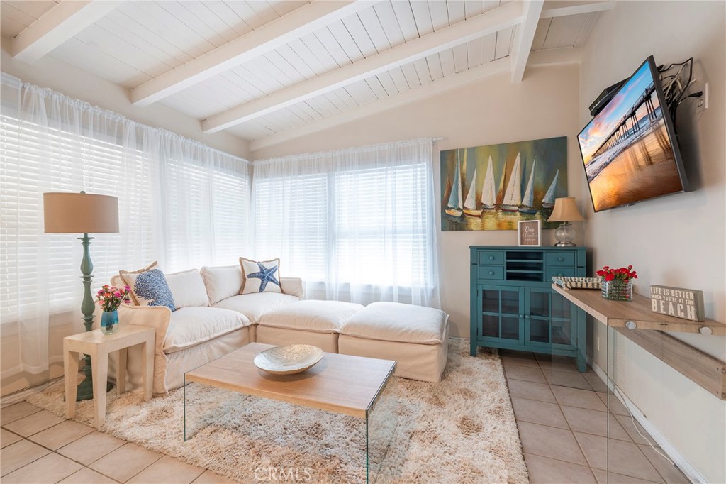1728 The Strand, Unit 4 Hermosa Beach, CA 90254 - Photo 6 of 23 a living room with furniture and a flat screen tv