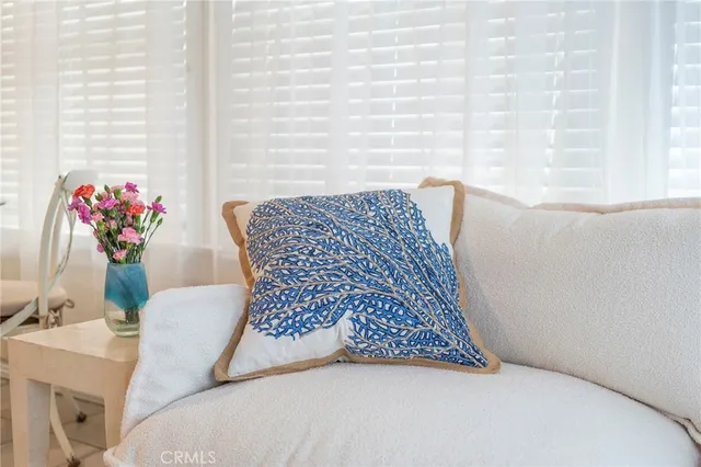 a living room with furniture and flowers