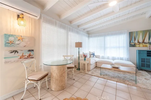 a living room with furniture a table and chairs