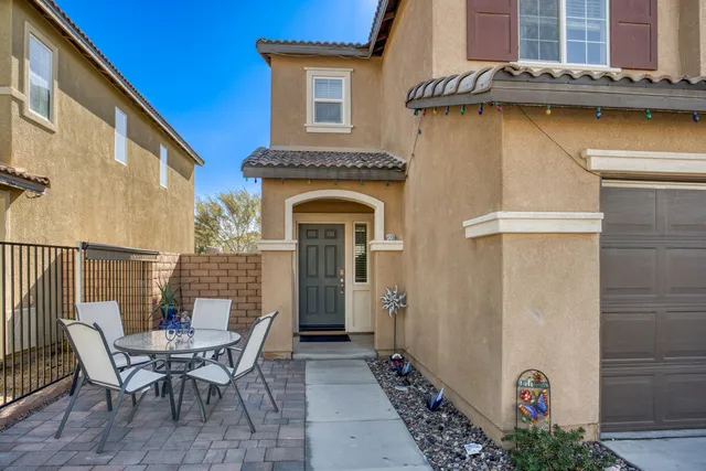 a view of a chair and table in the house front of house