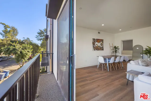 a view of a balcony dining table and chairs
