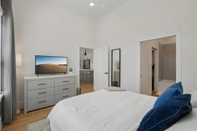 a bedroom with a bed and a dresser