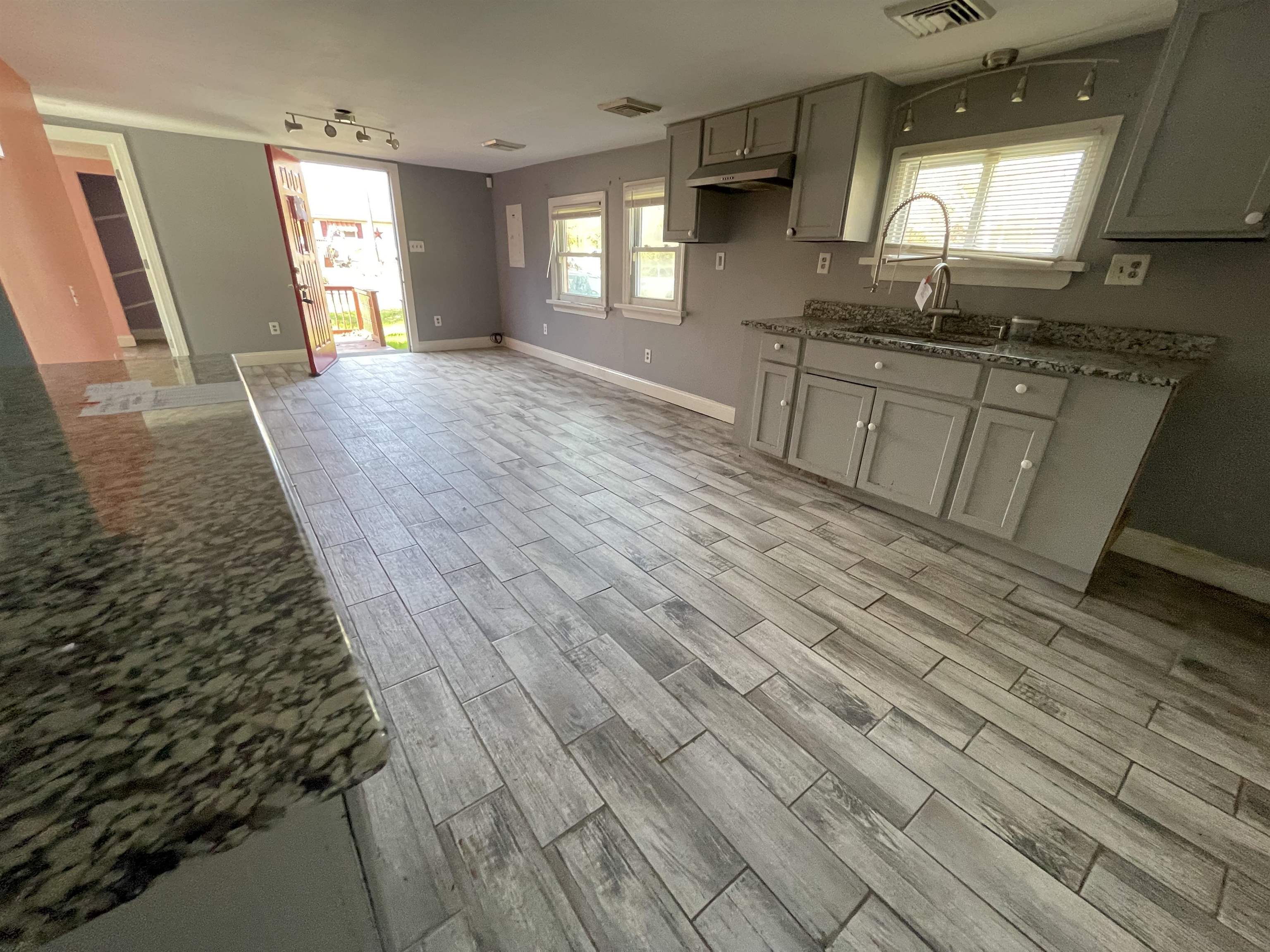 1658 North Port Norris, NJ 08349 - Photo 12 of 34 an empty room with wooden floor and windows