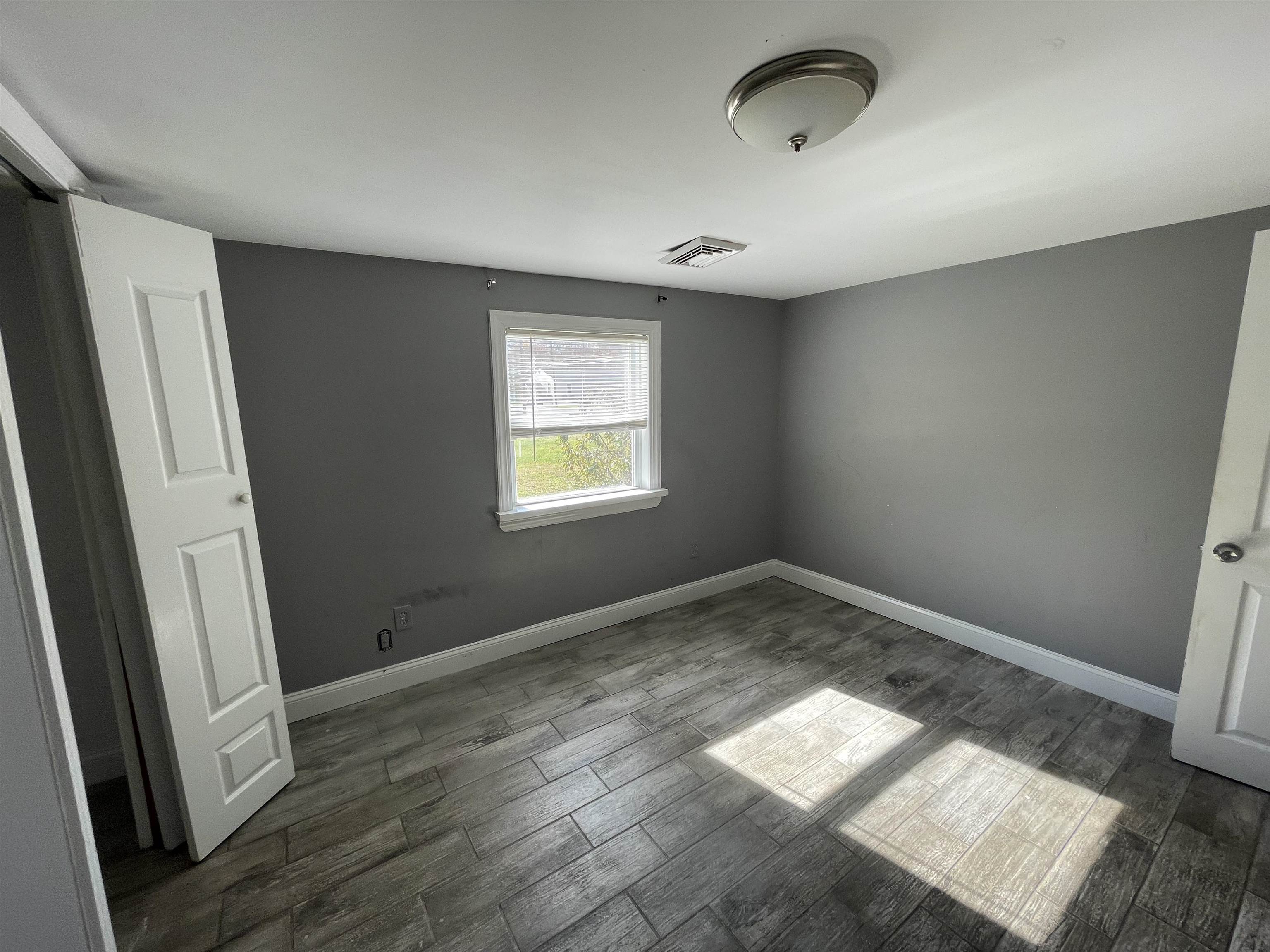 1658 North Port Norris, NJ 08349 - Photo 13 of 34 an empty room with wooden floor and windows