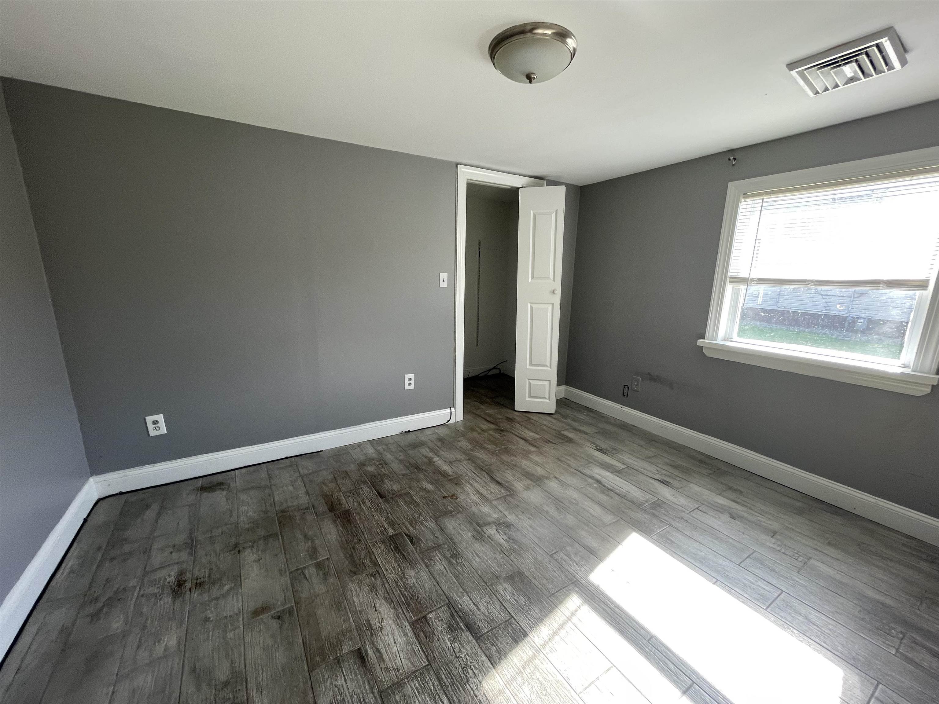 1658 North Port Norris, NJ 08349 - Photo 14 of 34 an empty room with wooden floor and windows