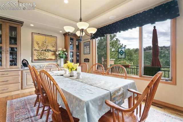 a view of a dining room with furniture wooden floor and chandelier