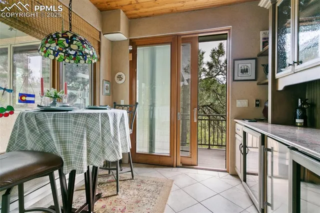 a dining room with furniture and a potted plant