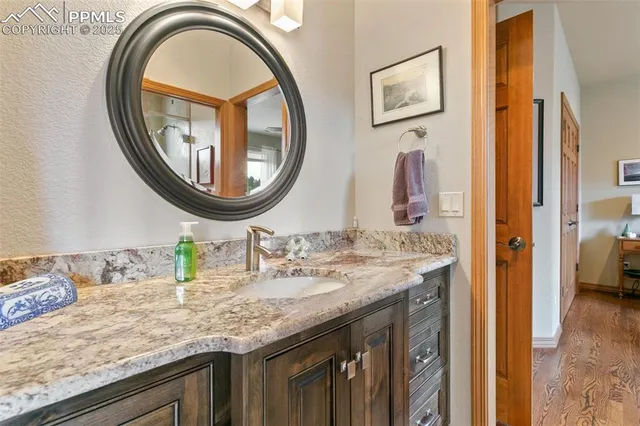 a bathroom with a granite countertop double vanity sinks and a mirror